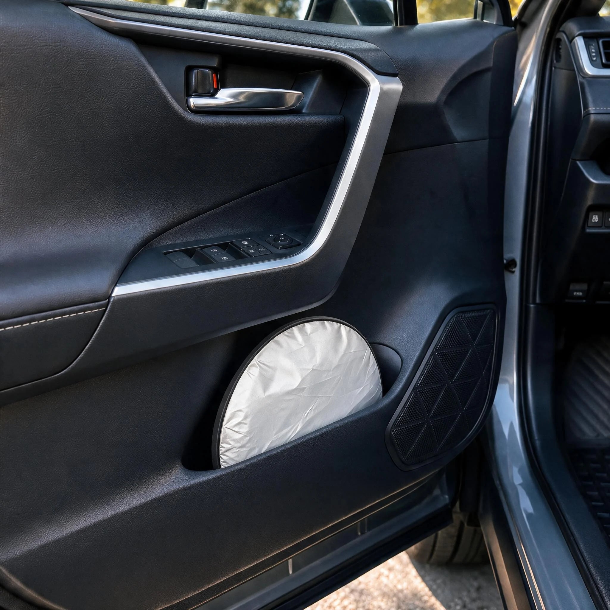Proadsy sunshade twist-folded to a compact disc, stored in a car door bin