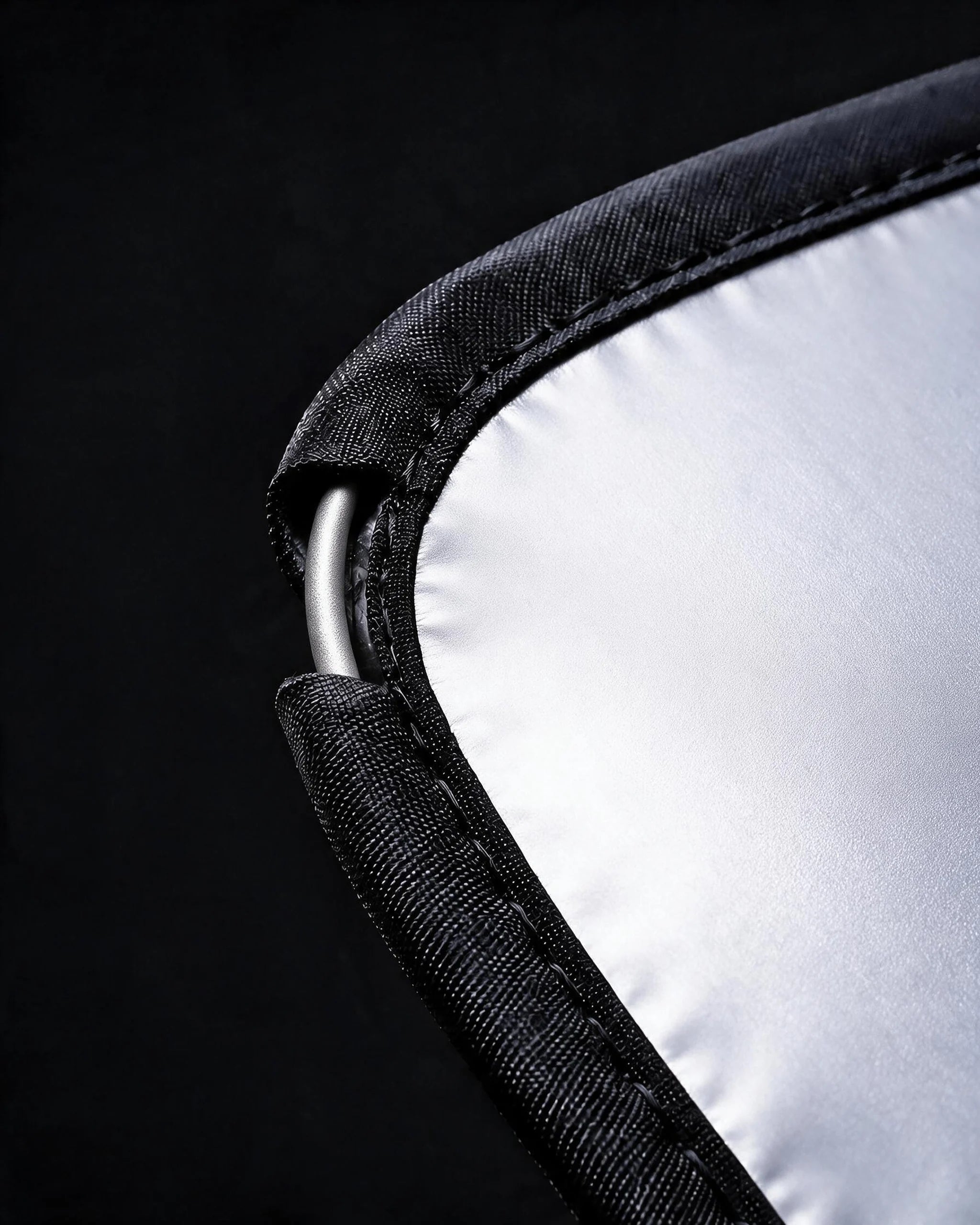 Macro shot of the Proadsy sunshade hem revealing the spring-steel perimeter frame wire